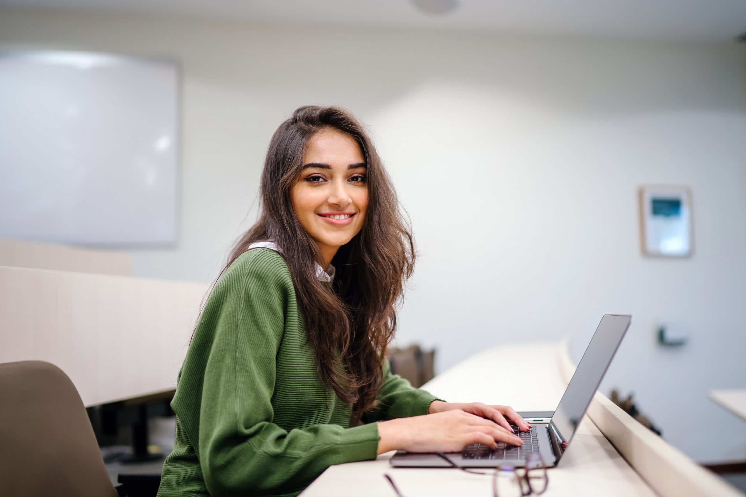 Student working on a laptop in a study space
